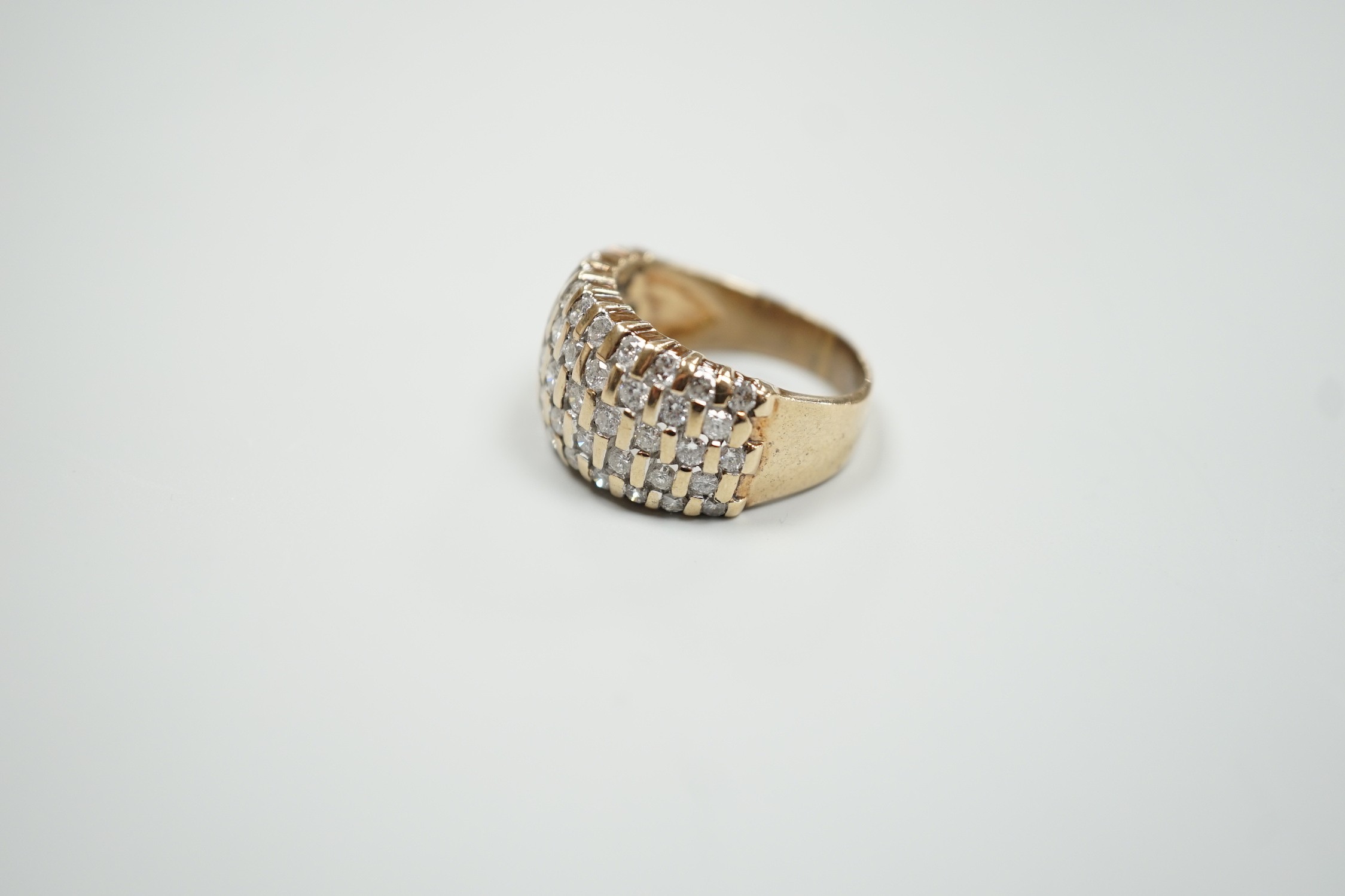 A modern yellow metal and pave set five row diamond dress ring, size R, gross weight 9.2 grams.